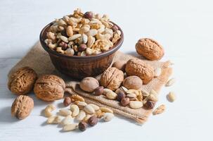 Mixed nuts on wood floor. Organic and fresh nuts. Copy space photo