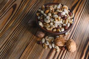 Various nuts on a plate, top view. photo