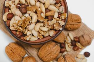 Various nuts on a plate, top view. photo
