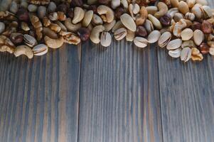Mixed nuts on wood floor. Organic and fresh nuts. Copy space photo