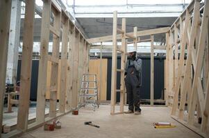 Worker carpenter assembling a modular house photo