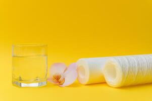 cartridges for water purification on a yellow background. Concept of clean water at home photo