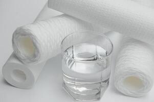 filter cartridges for water on a white background. Installation of reverse osmosis water purification system. photo