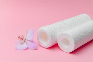 filter cartridges for water on a pink background. Installation of reverse osmosis water purification system. photo