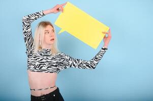 Youth transgender LGBT looking at camera while posing isolated over nude color background. photo