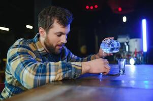 Sad man sitting at bar counter, alcohol addiction photo