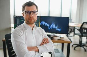 Serious business man trader analyst looking at computer monitor, investor broker analyzing indexes, financial chart trading online investment data on cryptocurrency stock market graph on pc screen. photo