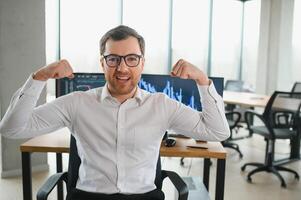 Successful trader in formalwear checking cryptocurrency information data on finance market graph, working in office photo
