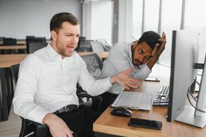 Two successful trader in formalwear pointing at display, analyzing stat and dynamic on forex charts, working in office together photo
