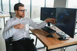 Serious business man trader analyst looking at computer monitor, investor broker analyzing indexes, financial chart trading online investment data on cryptocurrency stock market graph on pc screen. photo
