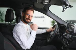 Man confident customer male buyer client wear white shirt choose auto want buy new automobile in showroom vehicle dealership store motor show indoor Sales concept. photo