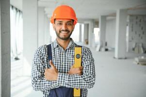 building, construction and people concept. Builder at construction photo
