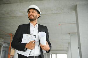 Asian Engineer standing on site construction posting confident , Engineer construction happy job success with in target planning photo