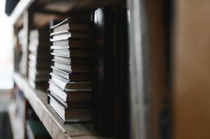 Blurred background of shelf with many multicolored books photo