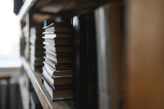Blurred background of shelf with many multicolored books photo