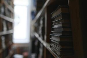 Blurred background of shelf with many multicolored books photo