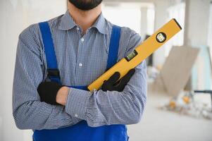 Worker checking vertical level with bubble level tool photo