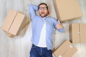 Smiling guy moving into his new home photo