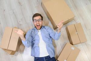 Smiling guy moving into his new home photo