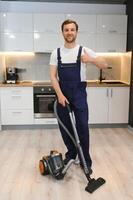 Man cleaning in the flat with vacuum cleaner photo