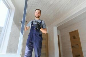 Process of construction new and modern modular house from composite sip panels. Worker man in special protective uniform wear working on building development industry of energy efficient property. photo