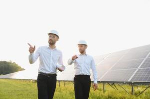 ingeniero y empresario cepillado nuevo ecología proyecto. alrededor solar panel techo foto