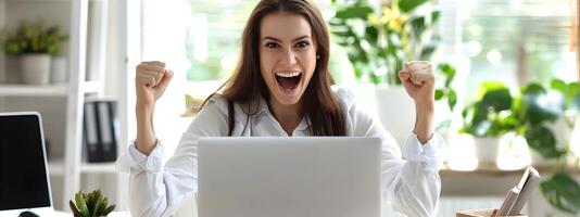 Delighted Administrative Manager Celebrates Career Milestone with Laptop at Office Desk photo