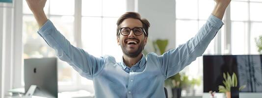 Enthusiastic Young Business Professional Celebrating Success at Office Desk photo