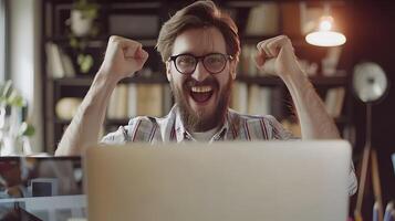 Joyful Young Professional Celebrating Successful Workday at Desk photo