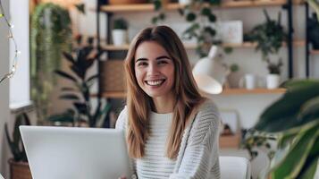 Smiling Young Woman Working Comfortably on Laptop in Cozy Home Office photo