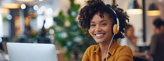 Confident African American Woman Happily Working with Laptop and Headphones in Modern Office photo