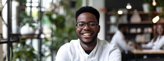 Confident Young African Professional Smiling at Desk photo