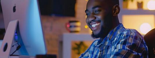 Happy African American Software Developer Coding at Workstation photo