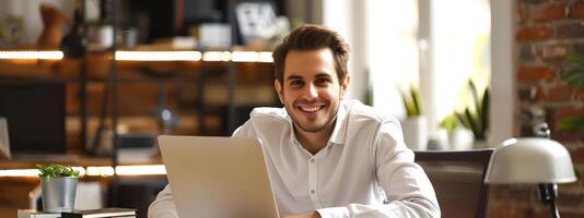 Hardworking Young Executive Happily Using Laptop at Office Desk photo