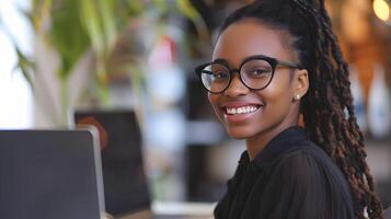 Smiling Young Professional Woman Working with Laptop in Office photo