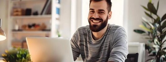 Smiling Young Web Developer Working Remotely on Laptop at Home Office photo