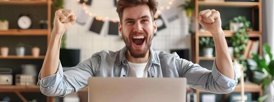 Thrilled Young Professional Celebrating Success at Computer Workstation photo