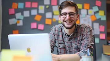 Cheerful Young Professional in Collaborative Workspace Reviewing Project Plans on Laptop photo