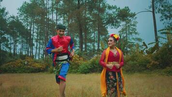 People in traditional Indonesian attire running in a field video