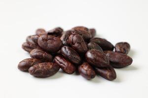 Roasted cocoa beans isolated on white background photo
