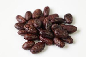 Roasted cocoa beans isolated on white background photo