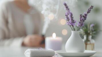 Serene spa setting with lavender flowers in a white vase, a lit candle, and a towel, perfect for relaxation and aromatherapy. photo