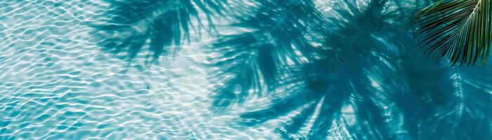 Tranquil pool scene with clear blue water and palm tree shadows, perfect summer vacation destination image for relaxation and leisure. photo