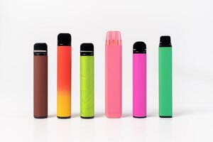 A set of colorful disposable electronic cigarettes of different shapes on a white background. modern smoking. photo