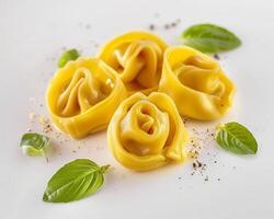 three ravioli with cheese and herbs on a white plate photo