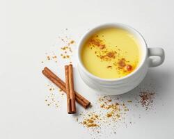 cinnamon and milk in a cup on a white background photo