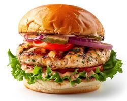 a chicken burger with lettuce, tomato and onion photo