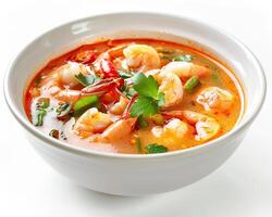 a bowl of soup with shrimp and vegetables photo