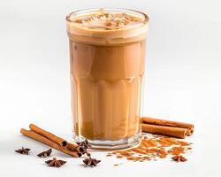 a glass of coffee with cinnamon and anise photo