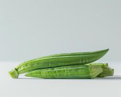 three okra on a white surface photo